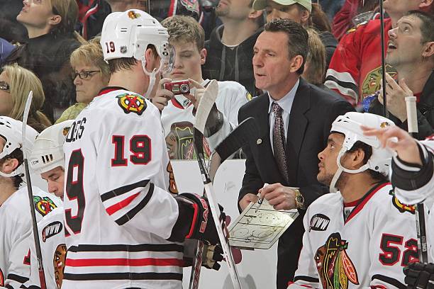 Chicago Blackhawks Head Coach Denis Savard offers instruction to Jonathan Toews of the Blackhawks during a game against the Columbus Blue Jackets on...